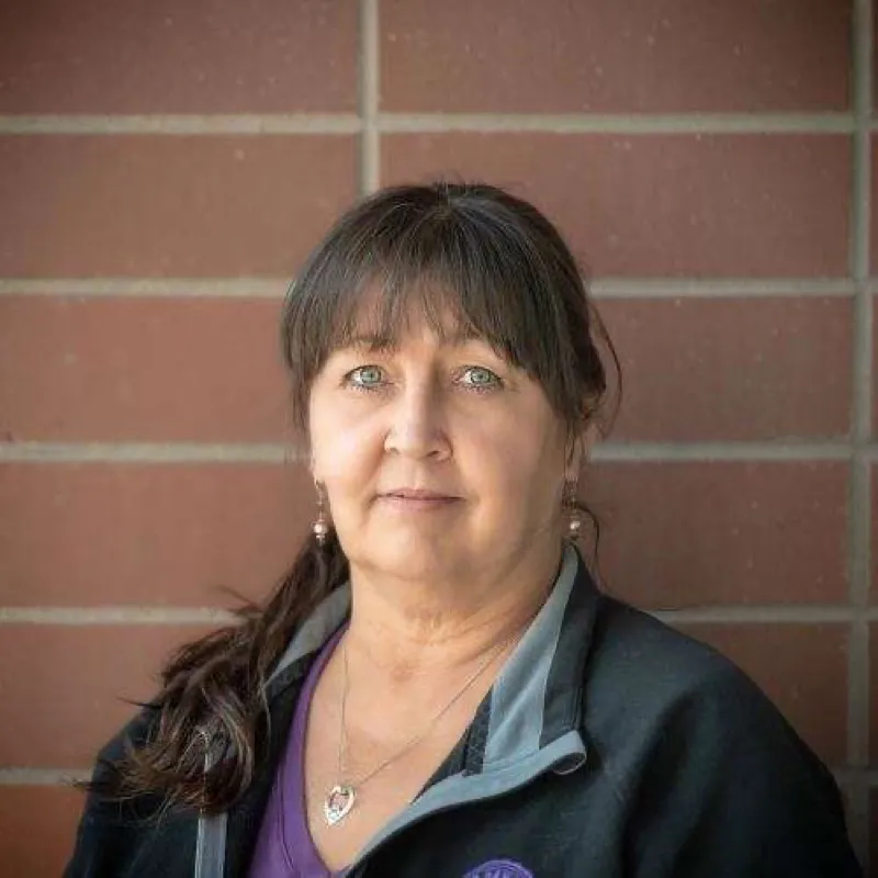 Michelle, professional dog groomer at PAWS Dog Daycare Calgary with over 40 years of experience